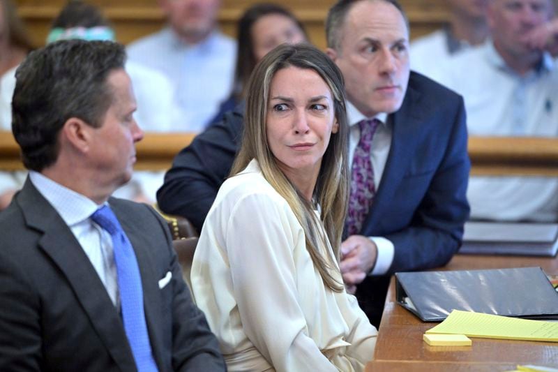 Karen Read, center, reacts to testimony from Dr. Irini Scordi-Bello, a medical examiner for the state's medical examiner's office during Read's trial in Norfolk Superior Court, Friday, June 21, 2024, in Dedham, Mass. Read, 44, is accused of running into her Boston police officer boyfriend with her SUV in the middle of a nor'easter and leaving him for dead after a night of heavy drinking. (AP Photo/Josh Reynolds, Pool)
