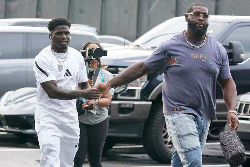 Miami Dolphins wide receiver Tyreek Hill, left, and offensive tackle Terron Armstead arrive for NFL football game against the Buffalo Bills, Thursday, Sept. 12, 2024, in Miami Gardens, Fla. (AP Photo/Lynne Sladky)