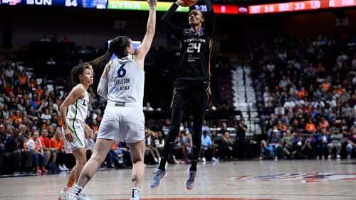 Connecticut Sun forward DeWanna Bonner (24) shoots over Minnesota Lynx forward Bridget Carleton (6) during the second half of Game 4 in the WNBA basketball semifinals, Sunday, Oct. 6, 2024, in Uncasville, Conn. (AP Photo/Jessica Hill)