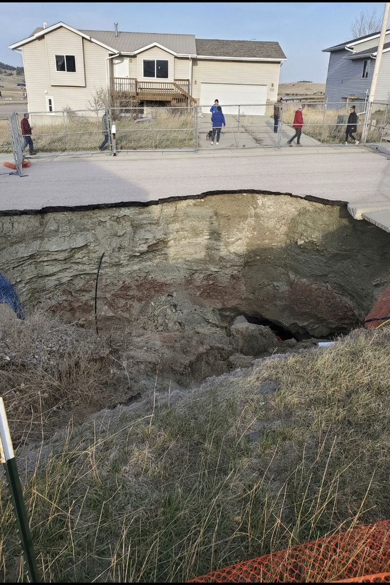 This photo taken April 27, 2022, by Tonya Junker shows a sinkhole in the Hideaway Hills neighborhood near Rapid City, S.D. (Tonya Junker via AP)