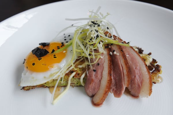 Smoked Pekin Duck with duck confit cabbage pancake, duck egg, spicy plum sauce.(BECKY STEIN PHOTOGRAPHY)