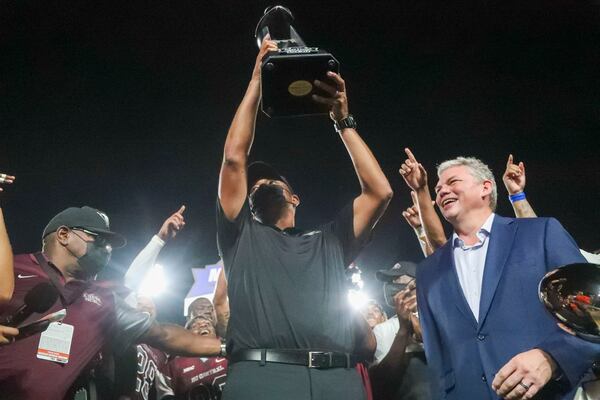 08/28/2021 — Atlanta, Georgia — In 2018, John Grant, CEO of the Cricket Celebration Bowl, added an early season game - the Cricket MEAC-SWAC Challenge - to the portfolio to kick off the college football season. Here, North Carolina Central Eagles head coach Trei Oliver raises the Cricket MEAC/SWAC Challenge trophy after beating the Alcorn State Braves following a football game at Center Parc Stadium in Atlanta, Saturday, August 28, 2021. (Alyssa Pointer/Atlanta Journal-Constitution)