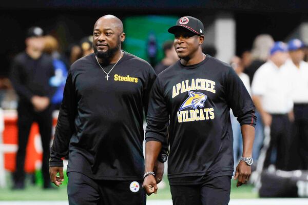 Falcons head coach Raheem Morris and the Pittsburg Steelers head coach Mike Tomlin interact moments before the game on Sunday, Sept. 8, 2024, at Mercedes-Benz Stadium in Atlanta. Morris wears an Apalachee High School shirt following a recent school shooting there in Winder, Ga.
(Miguel Martinez/ AJC)