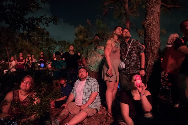 Lauren Uffner of Hollywood, Fla., center left, and Ozzy Morin of North Miami Beach, embrace while watching the fireworks show during the 40th annual Morikami Lantern Festival at the Morikami Museum in Delray Beach, Fla., on Saturday, October 21, 2017. The festival, which is inspired by the Japanese summer Obon festival, drew almost 5000 to celebrate the memories of loved ones with dances, games and the lighting of floating lanterns. (Andres Leiva / The Palm Beach Post)