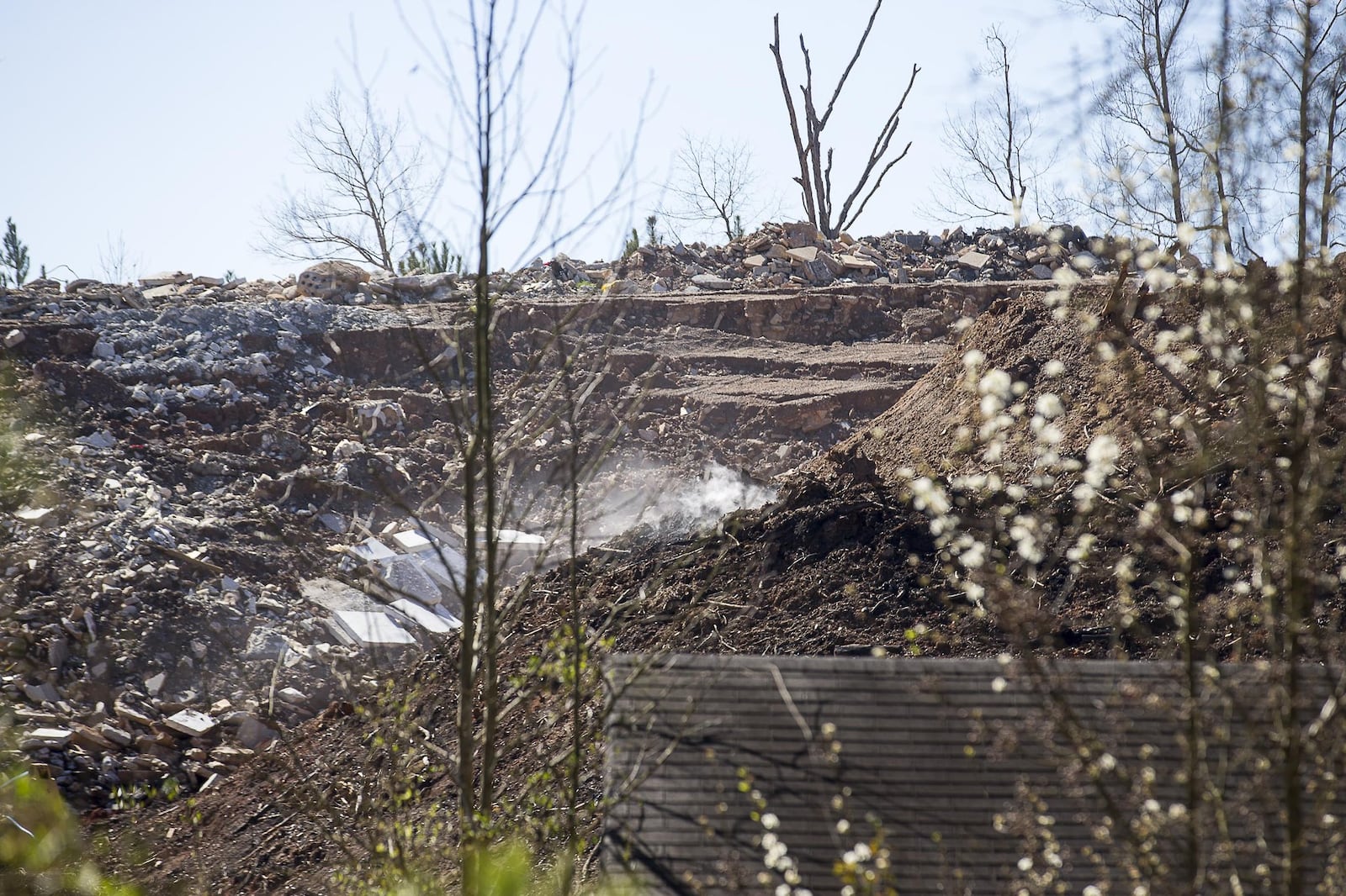 Smoke can be seen rising from an unlicensed landfill, located at 7635 Bishop Road, in South Fulton, Wednesday, February 13, 2019. (ALYSSA POINTER/ALYSSA.POINTER@AJC.COM)