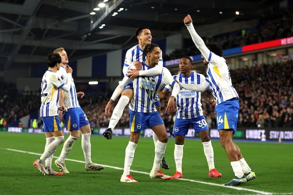 Brighton and Hove Albion's Joao Pedro, center, celebrates scoring his side's first goal of the game with team-mates during the English Premier League soccer match between Brighton and Hove Albion and AFC Bournemouth, at American Express Stadium, Brighton, England, Tuesday Feb. 25, 2025. (Steven Paston/PA via AP)