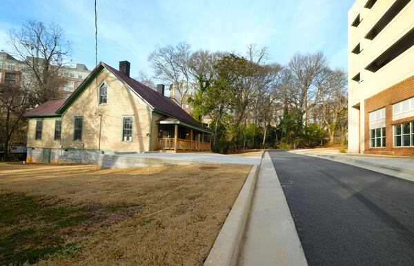 A lone house in Pottery Town in Athens, GA, surrounded by apartment buildings and a parking garage, used to be owned by Patterson Hood of the Drive-By Truckers. The house had to be moved from the original location because of the new construction in the area. (Nell Carroll for The Atlanta Journal-Constitution)