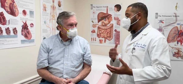 Dr. Cecil Bennett, the medical director of a primary care center in Newnan with a patient, Walter Eidson. 
CONTRIBUTED