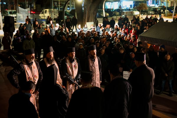 Priests perform a religious service during a vigil in the town of Kocani, North Macedonia, Tuesday, March 18, 2025 following a massive fire in a nightclub early Sunday. (AP Photo/Armin Durgut)