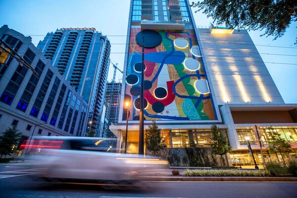 "Connect," a 10-story mural by artist Alex Webber, also known as HENSE, brightens up the side of the Icon Midtown apartment building. (Alyssa Pointer / Alyssa.Pointer@ajc.com)