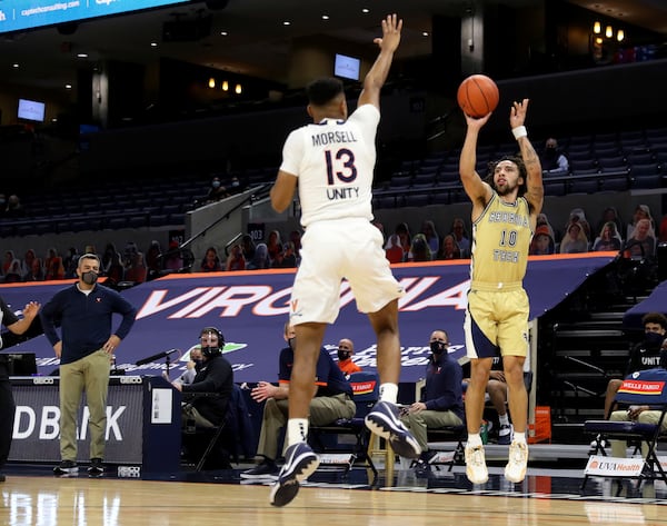 Georgia Tech guard Jose Alvarado (10) shoots over Virginia guard Casey Morsell (13) during an NCAA college basketball game Saturday, Jan. 23, 2021, in Charlottesville, Va. (Andrew Shurtleff/The Daily Progress via AP, Pool)