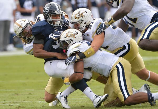 Georgia Southern running back Matt Breida (36) is taken down by Georgia Tech linebacker Chase Alford (left), Georgia Tech defensive end Rod Rook-Chungong (center) and Georgia Tech linebacker Brant Mitchell (51) in the first half at Bobby Dodd Stadium on Saturday, October 15, 2016. HYOSUB SHIN / HSHIN@AJC.COM