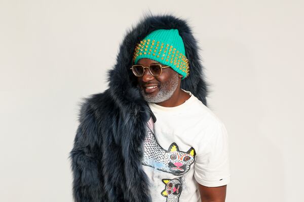 Fashion designer Daryl Mapp wears one of his signature beanies titled, “Crown of Cairo,” as he poses with his other designs at Bamboo Studio, Friday, December 13, 2024, in Atlanta. (Jason Getz / AJC)
