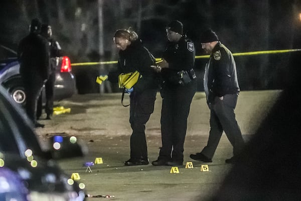 DeKalb County police investigators collect evidence during a shooting investigation Monday morning.