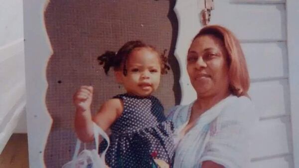 Meah Poret and her grandmother Roslyn Poret in front of the same New Orleans home that would be flooded out with them in it months before Hurricane Katrina hit. (Photo courtesy Christan Theresa Poret)