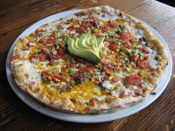 The spicy Mayan pizza at Fire Stone Wood Fired Pizza & Grill in Woodstock offers south of the border flavors like a poblano salsa, smoked shredded beef and corn pico. Photo: Fire Stone Wood Fired Pizza & Grill.