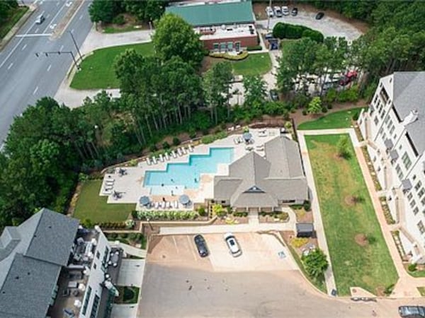 The pool is at the center of the property.