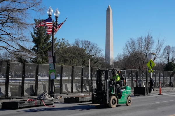 Workers install security fencing around the Ellipse near the White House ahead of the upcoming inauguration of Donald Trump in Washington.