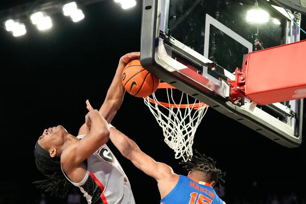 Georgia guard Silas Demary Jr. (5) puts up the ball against Florida guard Alijah Martin (15) during an NCAA college basketball game, Tuesday, Feb. 25, 2025, in Athens, Ga. (AP Photo/Brynn Anderson)