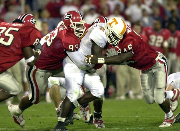 Georgia's Richard Seymour (left) tackles Tennessee's Travis Henry in 1999. (PHOTO BY JOHNNY CRAWFORD/STAFF)