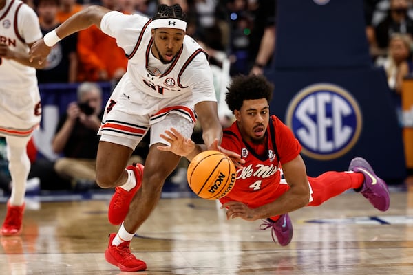 Auburn forward Chaney Johnson (31) and Mississippi forward Jaemyn Brakefield (4) chase a loose ball during the first half of an NCAA college basketball game in the quarterfinal round of the Southeastern Conference tournament, Friday, March 14, 2025, in Nashville, Tenn. (AP Photo/Wade Payne)