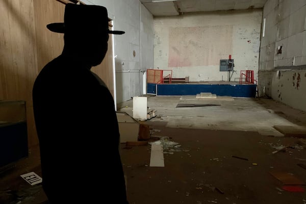 In this Monday, Jan. 13, 2020 photo, Rev. David Kennedy looks at a faded mural of nazi and confederate flags painted inside what was once "The Redneck Shop." His fight for civil rights is on display in the new film "Burden" in Laurens, S.C. (AP Photo/Sarah Blake Morgan)