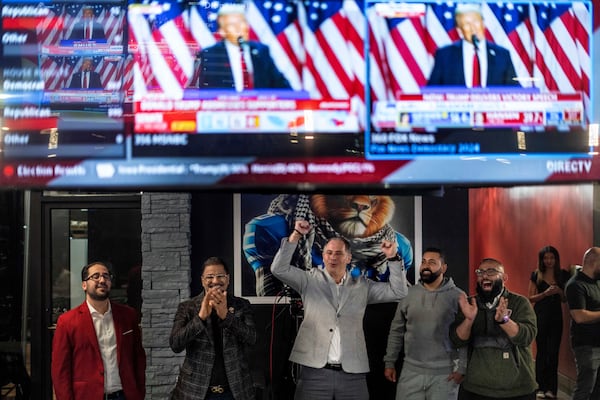 From left, Paul Manni, Sam Alasri, Wasel Yousaf, Waseem Makani and Abrahim Tamimi, cheer as Republican presidential nominee former President Donald Trump's speech is broadcast during an Arab Americans for Trump watch party at the Lava Java Cafe, a hookah lounge, in the early hours of Wednesday, Nov. 6, 2024, in Dearborn, Mich. (AP Photo/David Goldman)