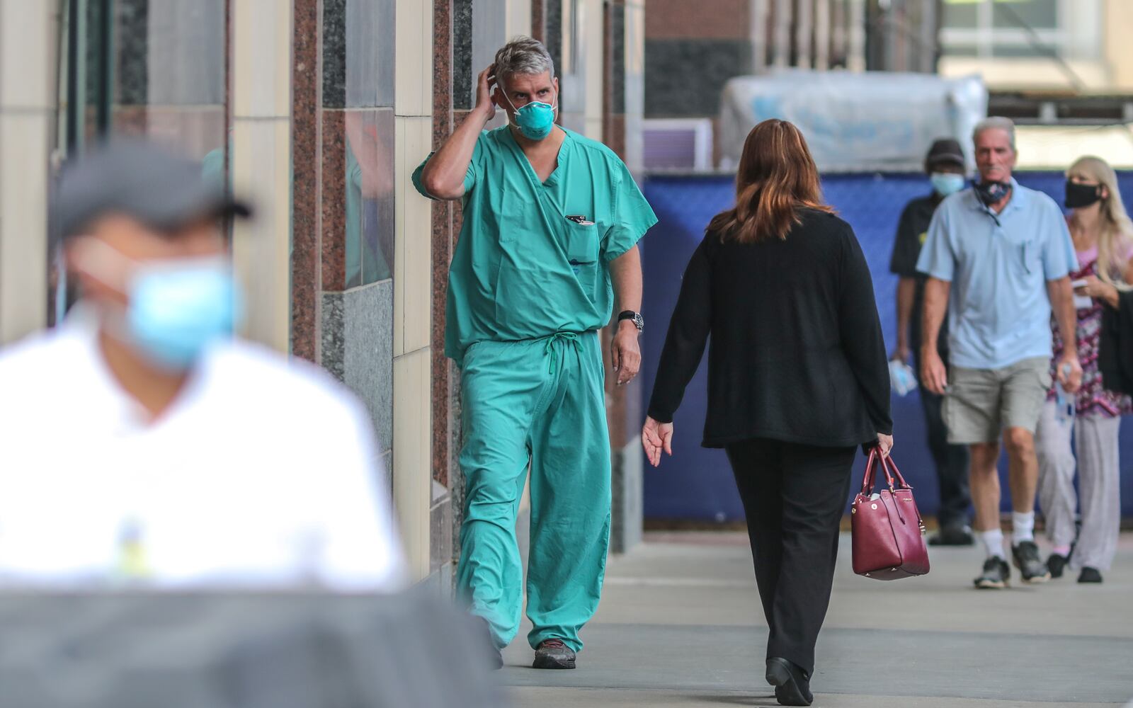 Dr. Chris Sadlack (center) walks outside Grady Hospital in downtown Atlanta on Thursday, July 9, 2020. Grady who along with other local hospitals are seeing a surge in new patients as cases reach record highs in Georgia. Grady is also experiencing a spike in trauma care patients. JOHN SPINK/JSPINK@AJC.COM