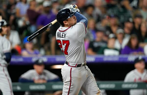 Atlanta Braves' Austin Riley follows the flight of his solo home run off Colorado Rockies starting pitcher Kyle Freeland in the sixth inning of a baseball game Saturday, June 4, 2022, in Denver. (AP Photo/David Zalubowski)