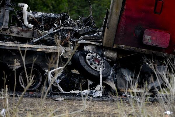 A tractor trailer sits on top of a crushed car after a multiple car accident on I-16 in Pooler, Ga. on Tuesday, May 19, 2015. (Ian Maule/Savannah Morning News via AP)