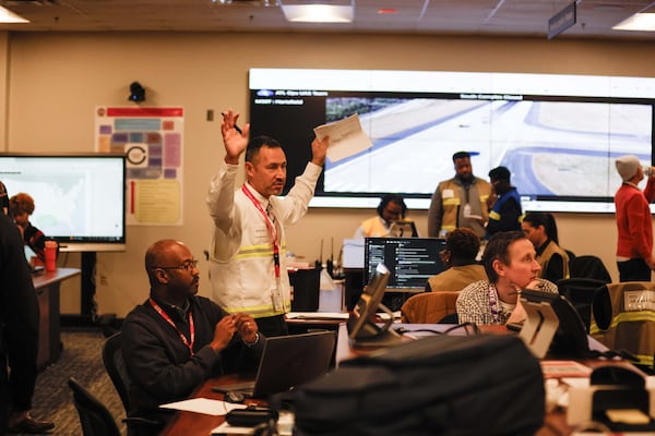 Various units of the Department of Aviation, along with several federal agencies and airline stakeholders, gather in the control room for a training session on weather emergency simulation operations on Wednesday, Dec. 4, 2024, at Hartsfield-Jackson International Airport in Atlanta. (Miguel Martinez/AJC)