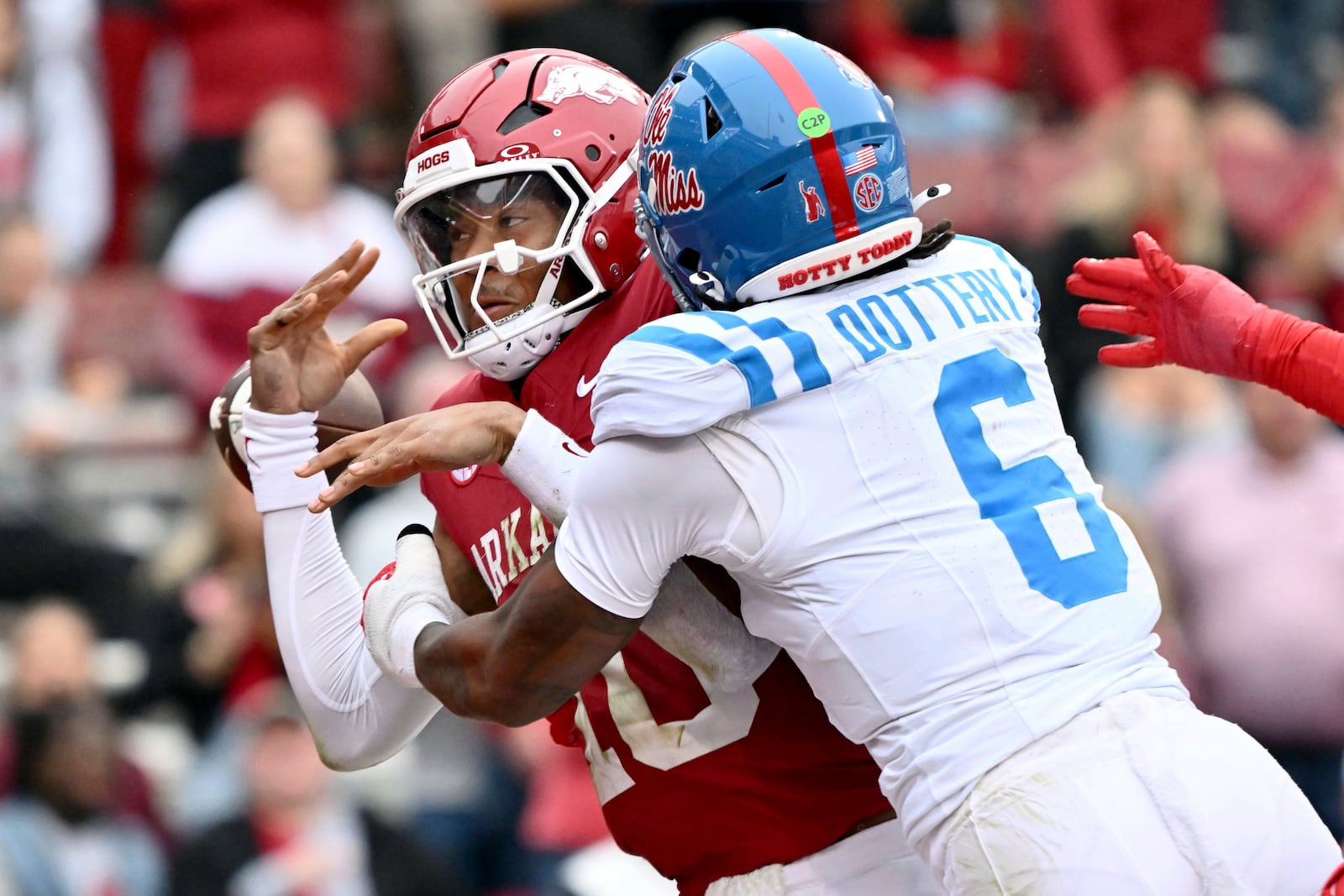 Mississippi linebacker TJ Dottery (6) knocks the ball out of the hands of Arkansas quarterback Taylen Green (10) in the end zone during the first half of an NCAA college football game Saturday, Nov. 2, 2024, in Fayetteville, Ark. The fumble was recovered for a touchdown by Mississippi defensive end Princely Umanmielen. (AP Photo/Michael Woods)