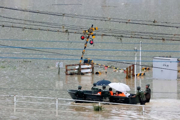 Heavy rain in the Kumamoto region triggered flooding and mudslides Saturday and left dozens stranded at their homes and other facilities.