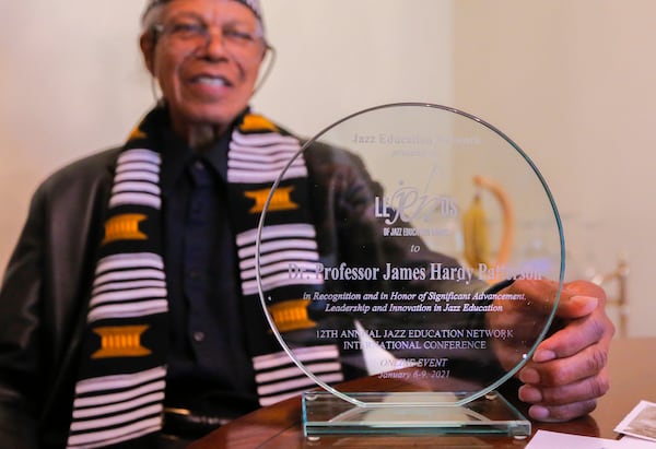 James Patterson poses for a portrait with an award he received, the JEN LeJENds of Jazz Education Award, at his home in Atlanta on Friday, July 2, 2021. Patterson is a longtime jazz musician as well as an associate music professor at Clark Atlanta University. The award honors jazz educators who have demonstrated service to the community. (Christine Tannous / christine.tannous@ajc.com)