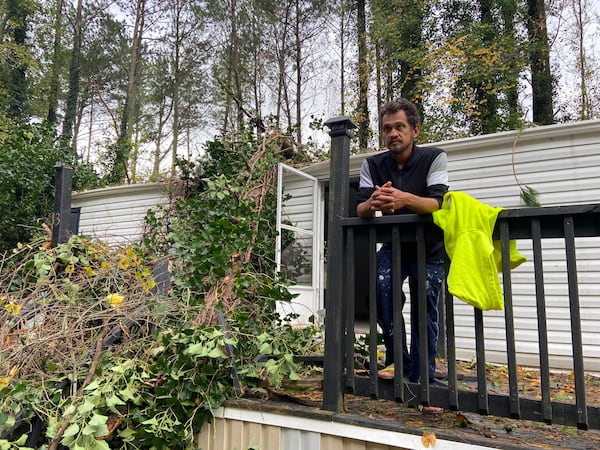 Gaby Lopez evacuated his Acworth home early Thursday, shortly before a tree crashed through his bedroom.