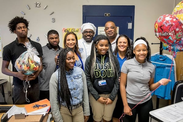 Atlanta Public Schools High School Teacher of the Year and APS Districtwide Teacher of the Year finalist Chef Larry Alford of Alonzo Crim Open Campus is surrounded by district officials and some of his students.							Photo courtesy of Ben Dashwood, Raftermen Photography