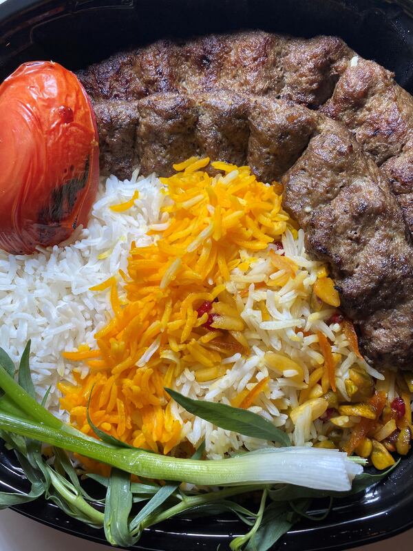 Koobideh kabob features two skewers of ground brisket, tomato and basmati rice. Bob Townsend for The Atlanta Journal-Constitution.