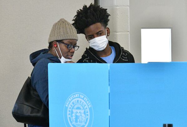 October 22, 2022 Stone Mountain - Linda Settles talks with her son Channing Settles, 18, who is a first time voter, before they cast their ballots at an early voting location in Mountain Park Activity Building in Stone Mountain on Saturday, October 22, 2022. A record-breaking week of early voting continues Saturday, the first weekend voting day of the general election season. Some 729,029 people cast ballots Monday through Friday, far surpassing the 488,177 people voted during the same period in the 2018 midterm election. (Hyosub Shin / Hyosub.Shin@ajc.com)