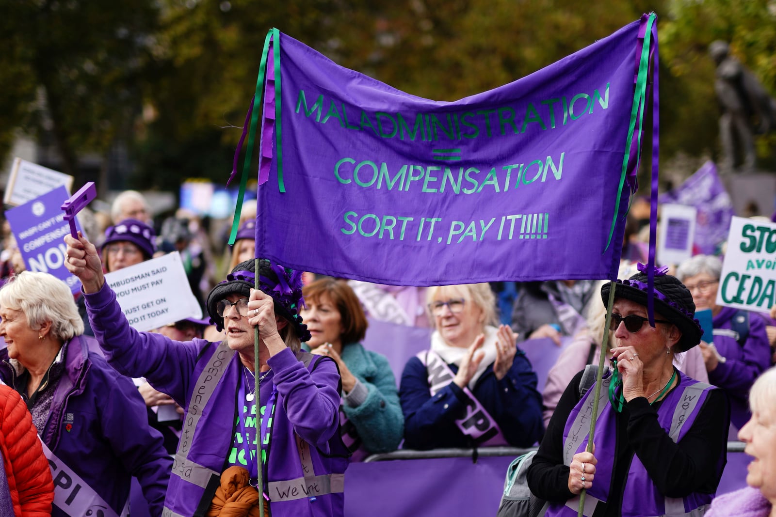 Waspi (Women Against State Pension Inequality) campaigners stage a protest on College Green in Westminster, London, as Chancellor of the Exchequer Rachel Reeves delivers her Budget in the Houses of Parliament, Wednesday, Oct. 30, 2024. (Jordan Pettitt/PA via AP)