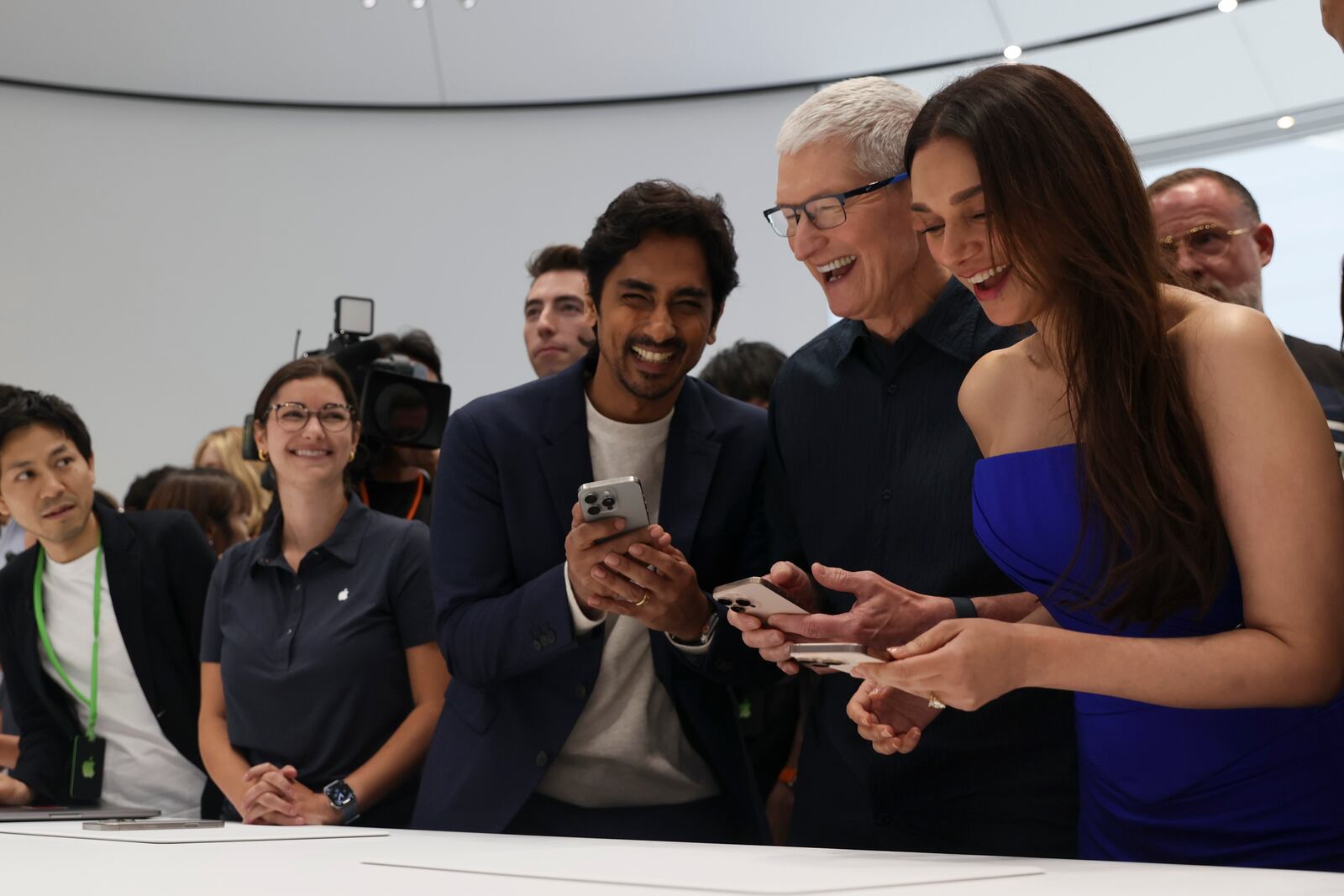 Apple CEO Tim Cook, second from right, smiles as he shows the new iPhone 16 model to attendees at Apple headquarters Monday, Sept. 9, 2024, in Cupertino, Calif. (AP Photo/Juliana Yamada)