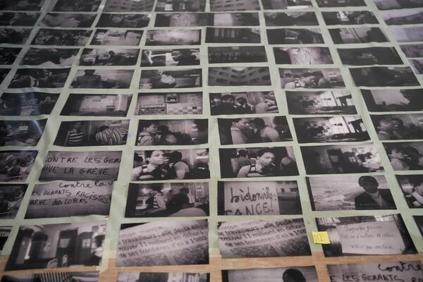 Archive images are displayed during the preparation of a mural by French street artist Shuck One for the exhibition "Paris Noir", at the Centre Pompidou Museum, in Paris, Tuesday, Feb. 18, 2025. (AP Photo/Thibault Camus)