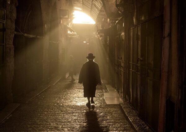 Dalia Rajuan's photograph of a pedestrian in the Old City is included in the exhibit "JerusaLENS" at the Breman.