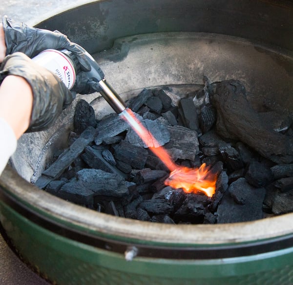  Lighting the Big Green Egg. / CONTRIBUTED BY HENRI HOLLIS