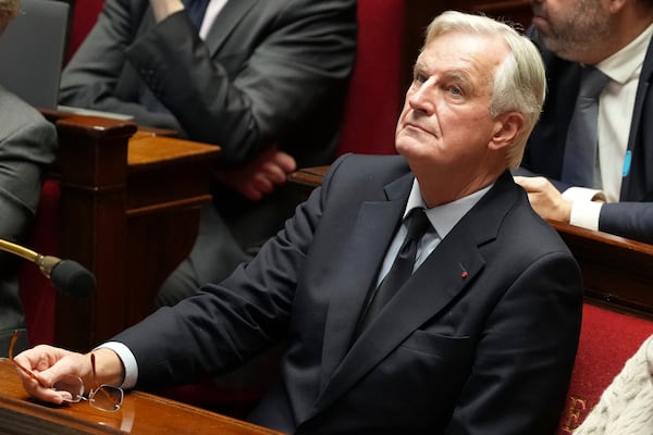 French Prime Minister Michel Barnier attends a debate at the National Assembly while France's minority government may be on its last legs as opposition lawmakers moved this week toward a no-confidence vote, Monday, Dec. 2, 2024 in Paris. (AP Photo/Michel Euler)