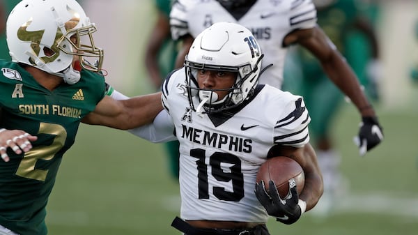 Memphis running back Kenneth Gainwell (19) pushes off South Florida defensive back Nick Roberts (2) during the first half Saturday, Nov. 23, 2019, in Tampa, Fla. (Chris O'Meara/AP)