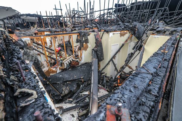 The view Thursday morning shows the charred remains of the Avana on Main. The Buckhead apartment was destroyed in a fire Wednesday afternoon. JOHN SPINK/JSPINK@AJC.COM

