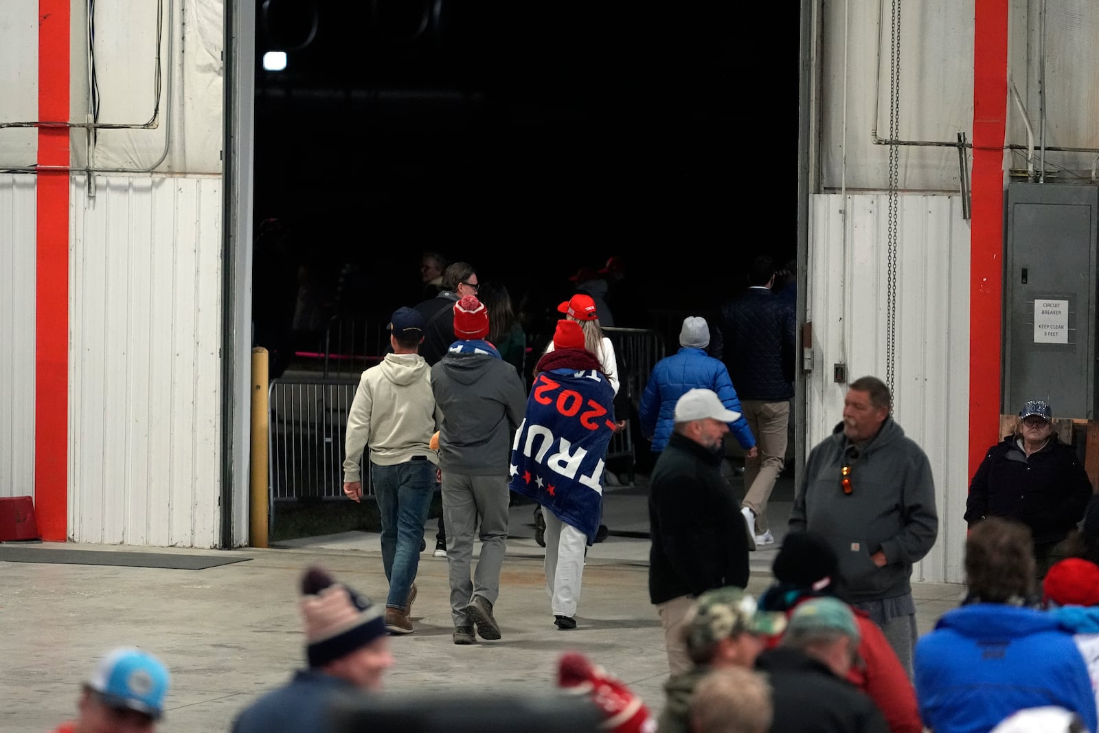 Attendees leave a campaign event for Republican presidential nominee former President Donald Trump before he arrives Friday, Oct. 25, 2024, in Traverse City, Mich. (AP Photo/Paul Sancya)