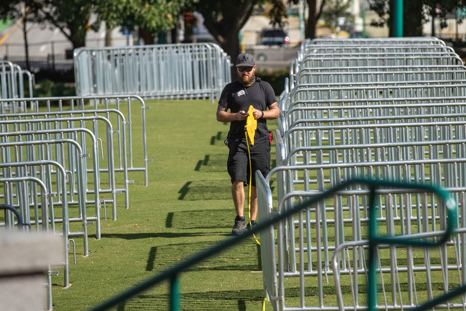 A crew member uses measuring tape to social distance each private pod for the "Big Night Out" concert series at Centennial Olympic Park in downtown Atlanta on Thursday, October 22, 2020. (Photo: Alyssa Pointer / Alyssa.Pointer@ajc.com)