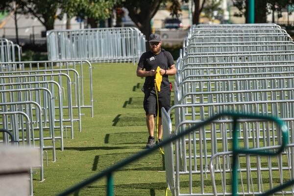 A crew member uses measuring tape to social distance each private pod for the "Big Night Out" concert series at Centennial Olympic Park in downtown Atlanta on Thursday, October 22, 2020. (Photo: Alyssa Pointer / Alyssa.Pointer@ajc.com)