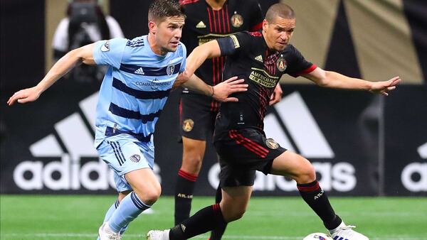 Atlanta United midfielder Ozzie Alonso (right) works against Sporting KC in a MLS soccer match Sunday, Feb. 27, 2022, in Atlanta.  “Curtis Compton / Curtis.Compton@ajc.com”`